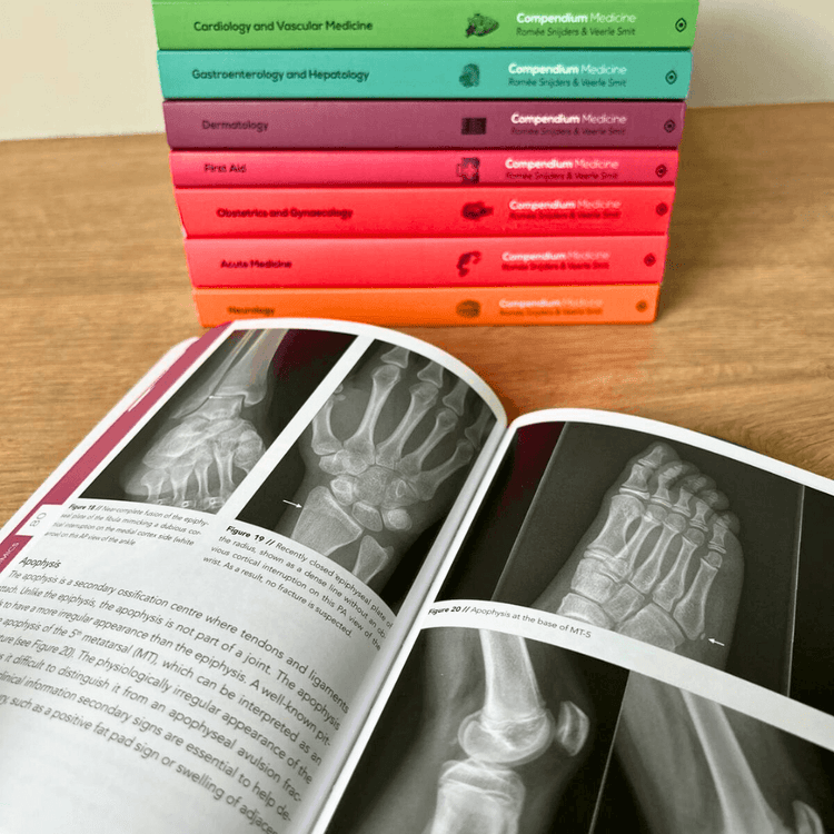 Stack of colorful medical books with an open book showing radiographic images.